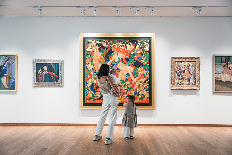 A family in front of art